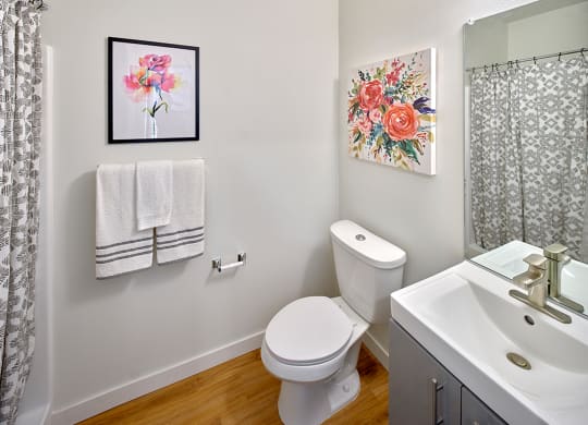 a bathroom with a toilet and a sink and a shower at Enve, Seattle, 98102