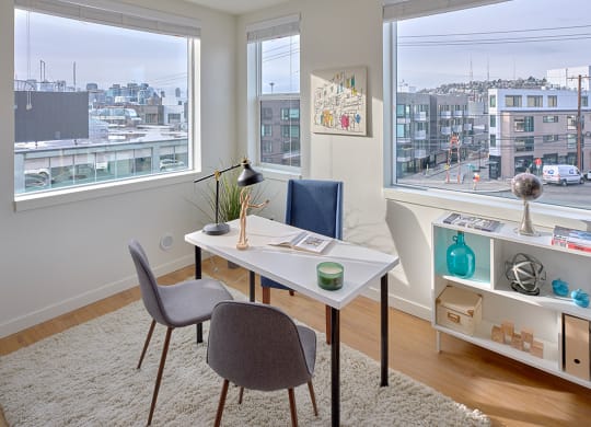a living room with a desk and two chairs and a window  at Enve, Seattle, WA 98102