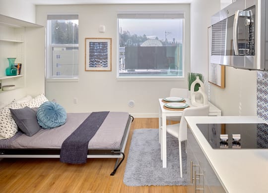 a bedroom with a bed and a desk and a window at Enve, Seattle, WA, 98102