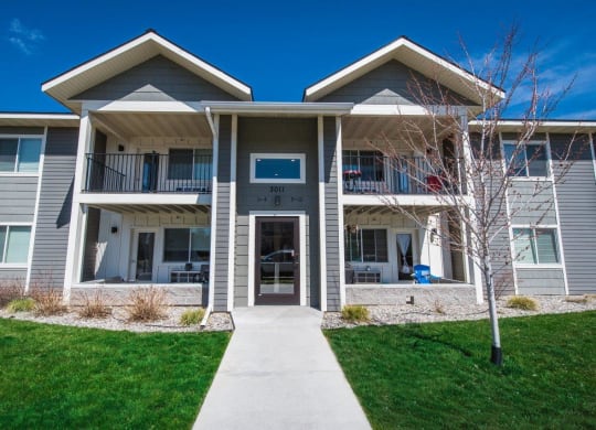 a building with a sidewalk in front of it at Madison Park, Bozeman, MT