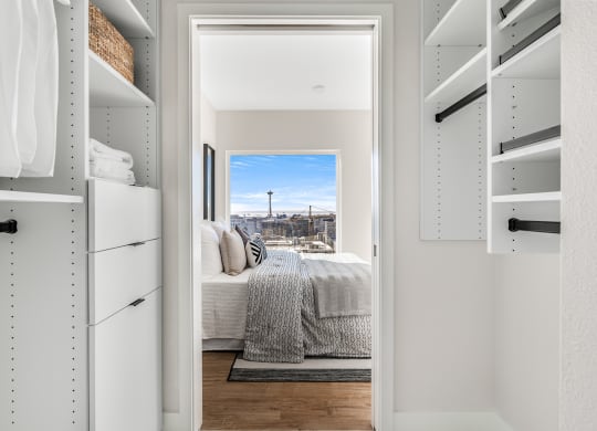 a walk in closet with a bed and a city view  at Oslo, Seattle, Washington
