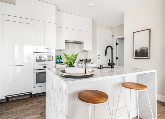 a kitchen with white cabinets and a counter top  at Oslo, Seattle, 98102