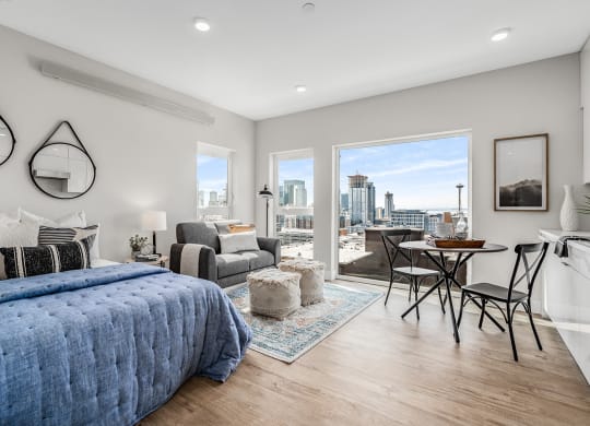 a bedroom with a large bed and a view of the city  at Oslo, Seattle, WA, 98102
