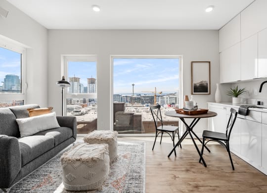 a living room and kitchen with a view of the city  at Oslo, Seattle, 98102