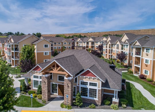 an aerial view of an apartment complex with trees and buildings at Quail Springs, West Richland, WA