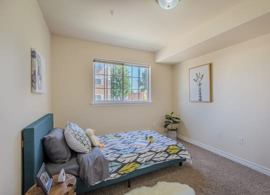 a bedroom with a bed and a couch in front of a window  at Quail Springs, West Richland