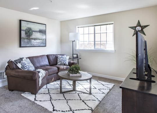 a living room with a couch and a coffee table  at Quail Springs, Washington