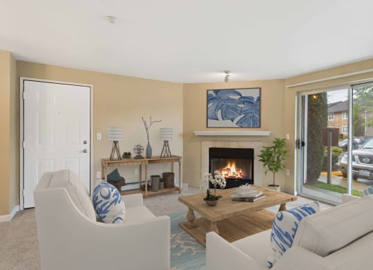 a living room with couches and a fireplace and a door at Quartz Creek, Washington