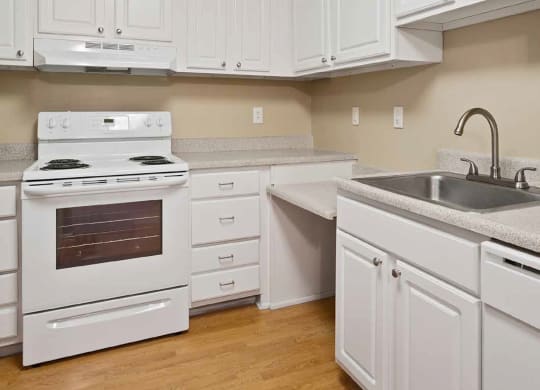 a kitchen with white cabinets and a stove and a sink at Quartz Creek, Washington, 98043