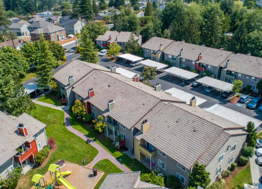 an aerial view of a neighborhood of houses with roofs at Quartz Creek, Washington