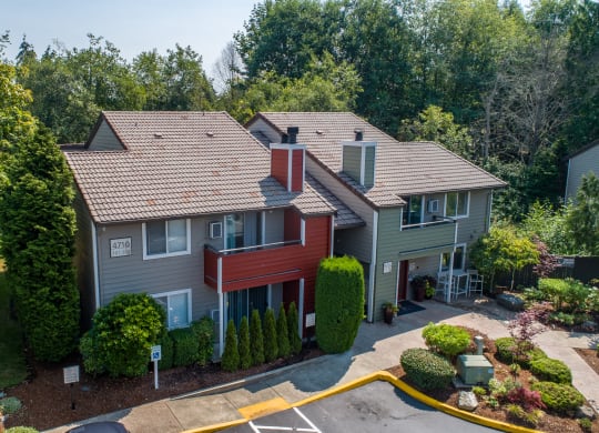 an aerial view of a home with a red and gray house and trees at Quartz Creek, Washington