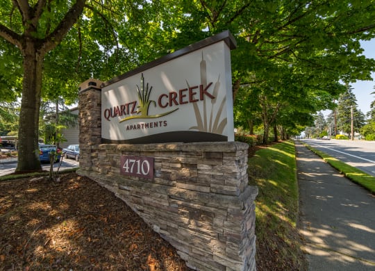 a sign for center creek apartments on the side of a road at Quartz Creek, Washington