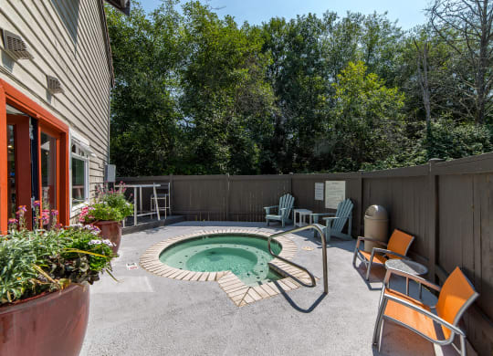 a backyard with a pool and patio with chairs and a table at Quartz Creek, Washington, 98043