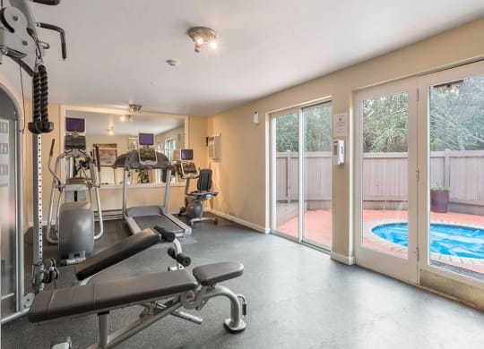 a gym with weights and a pool in the corner at Quartz Creek, Washington