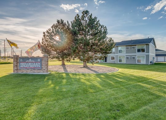 the yard of a house with a tree and a sign at Shiloh Glen, Billings, 59102