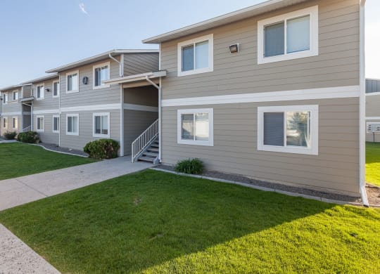 a sidewalk in front of a building with grass at Shiloh Glen, Billings Montana