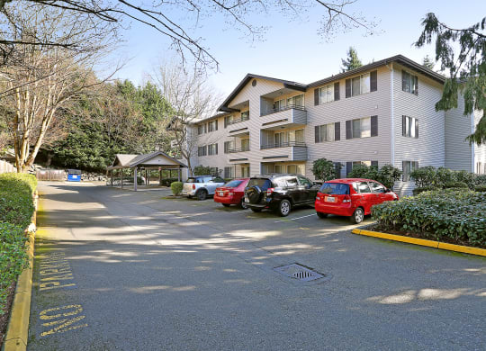 a large apartment building with cars parked in front of it  at Townside Flats, Redmond, Washington