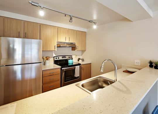 a kitchen with stainless steel appliances and a granite counter top  at Townside Flats, Redmond, Washington