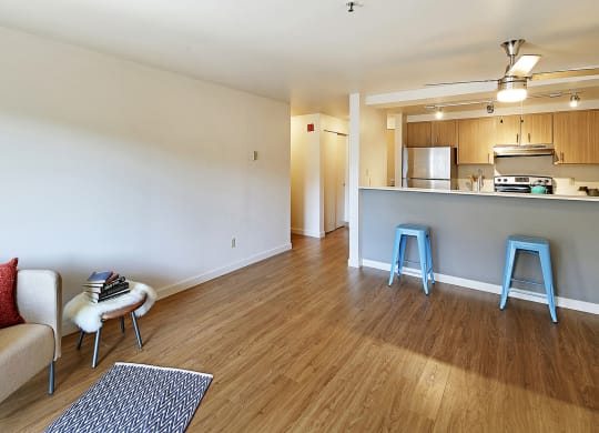 a living room and kitchen with blue stools  at Townside Flats, Washington
