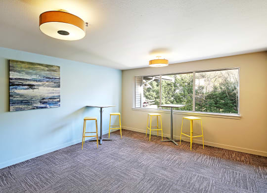 an empty room with bar stools and a window  at Townside Flats, Redmond