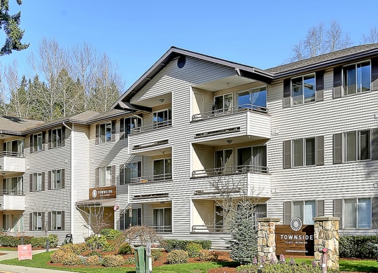 a large condo building with a street in front of it  at Townside Flats, Redmond, Washington