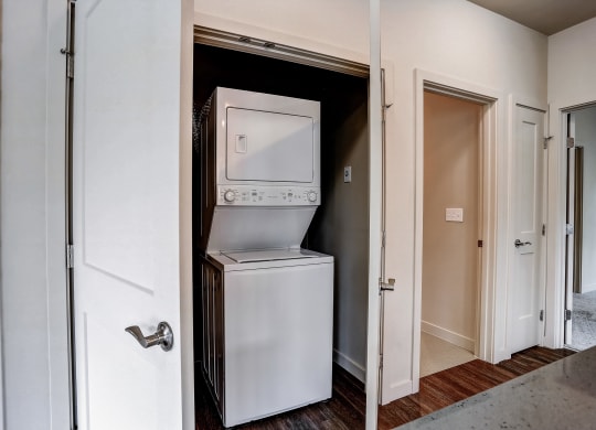 a small closet with a refrigerator and a washing machine in it at Woodcreek, Washington