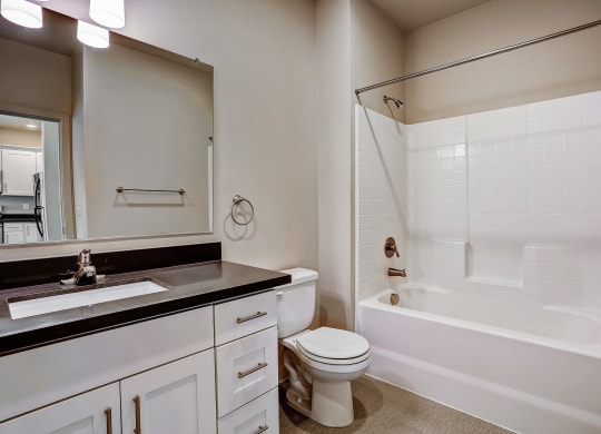 a bathroom with a toilet and a tub and a sink at Woodcreek, Washington, 98370