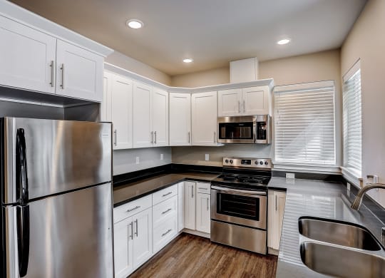 a kitchen with white cabinets and stainless steel appliances at Woodcreek, Poulsbo, 98370