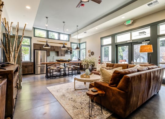 a large living room with a leather couch and a table at Woodcreek, Washington, 98370