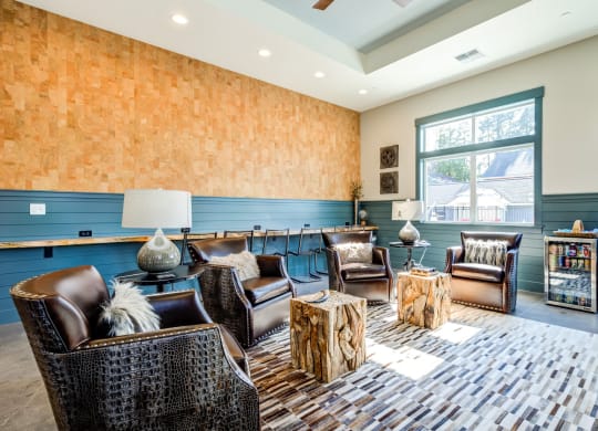 a living room with chairs and tables and a large window at Woodcreek, Poulsbo Washington