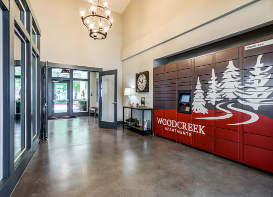 the lobby apartments with a reception desk and a wood creek partners sign at Woodcreek, Poulsbo, 98370