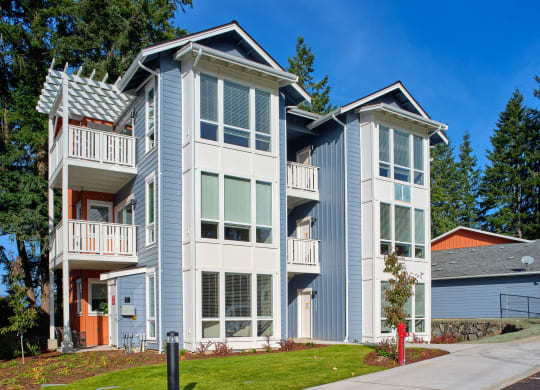 a blue and white house with a sidewalk in front of it at Woodcreek, Poulsbo, 98370