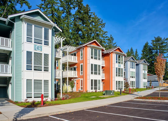 a row of colorful town houses on a sidewalk at Woodcreek, Poulsbo, WA