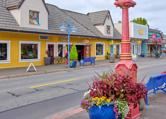 a large clock on the side of a street with a vase of flowers at Woodcreek, Washington, 98370