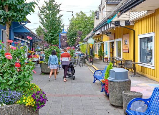 a couple of people walking down a sidewalk with a stroller at Woodcreek, Washington