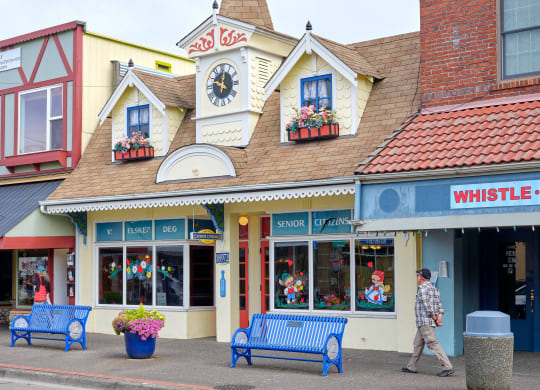 a man walking down the street in front of a store at Woodcreek, Poulsbo, WA