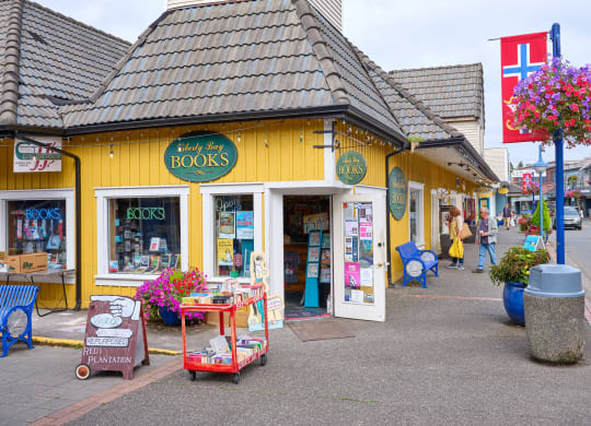 a yellow store with books on the side of a street at Woodcreek, Washington, 98370