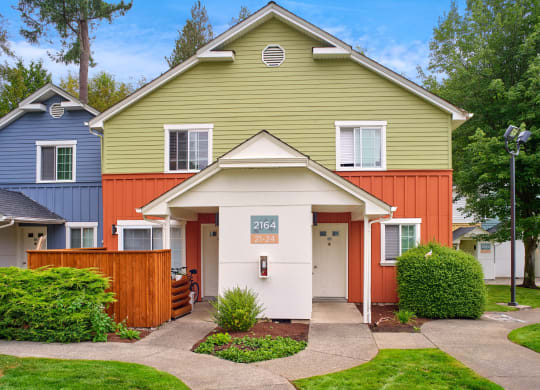 the front of a house with a porch and a sidewalk at Woodcreek, Poulsbo Washington 