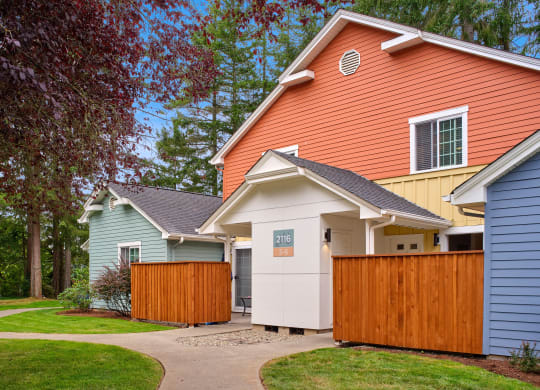 a group of houses with a sidewalk and a fence at Woodcreek, Poulsbo, 98370