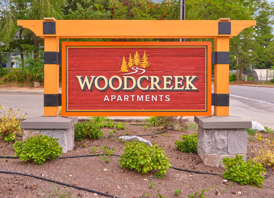 a sign for wood creek apartments on the side of the road at Woodcreek, Poulsbo, WA