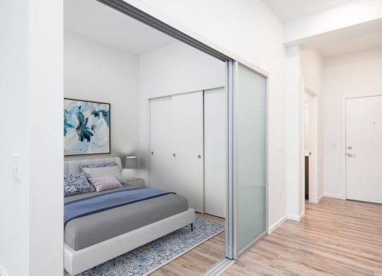 a bedroom with a bed and a sliding glass door