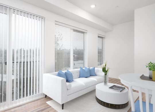 a living room with a white couch and a table