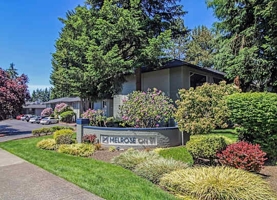 A sign that says Melrose Court in front of a building.