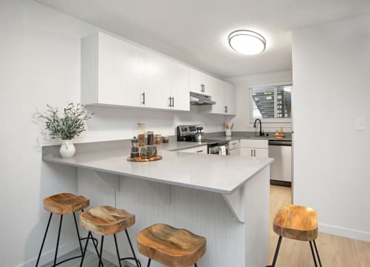 a kitchen with a large island with three stools at Brix, Washington, 99362