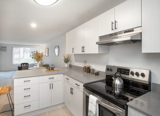 an open kitchen with white cabinets and stainless steel appliances at Brix, Walla Walla, WA, 99362
