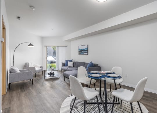 a living room with a couch and a table and chairs  at Shoreline Village, Richland, WA, 99352