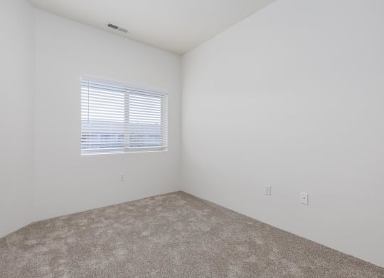 an empty room with a window and carpet  at Shoreline Village, Washington