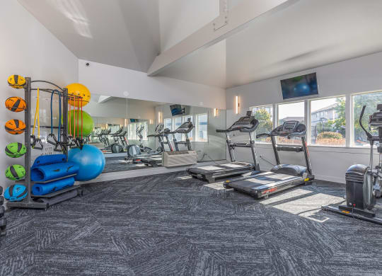 a gym with treadmills and other exercise equipment at the enclave at university heights  at Shoreline Village, Richland, WA