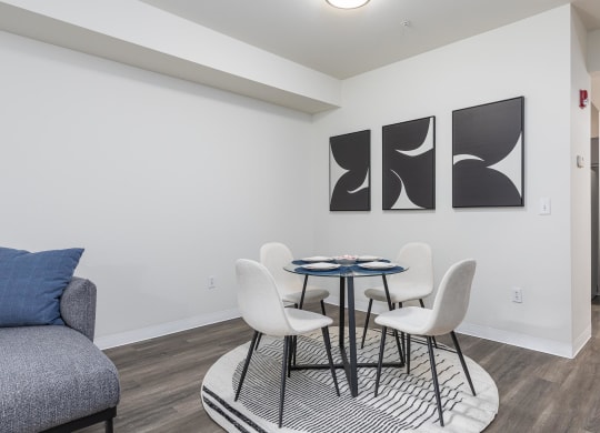 a dining room with a table and chairs and a couch  at Shoreline Village, Richland, 99352