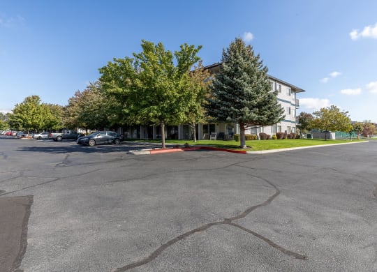 a parking lot in front of a building with trees  at Shoreline Village, Richland, Washington